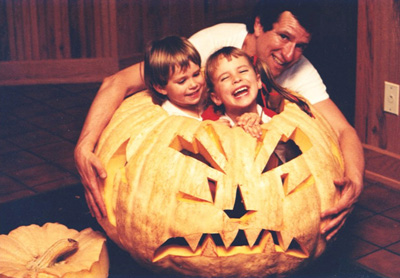 Dentist Thomas Pray wrapped his arms around children Jessica and John inside a large pumpkin shell.